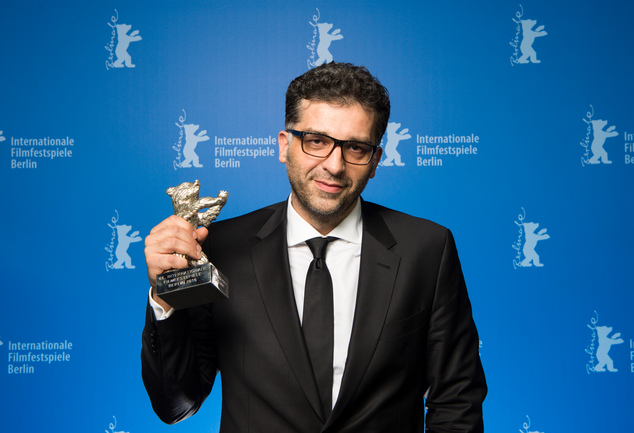 Danis Tanovic, the director of ''Smrt u Sarajevu') shows off a Silver Bear he was awarded as Grand Jury Prize during the award ceremony of the 2016 Berlin Film Festival Berlinale on Saturday, Feb. 20, 2016 in Berlin. (Bernd von Jutrczenka/pool photo via AP)