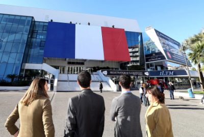 A giant French flag set up on the Cannes festival palace in Cannes , southeastern France Friday, Nov. 27, 2015. French President Francois Hollande called on his compatriots to hang French tricolor flags on Friday to pay homage to the victims of the Nov. 13, attacks, an unusual appeal by a Socialist leader in a country where flag-waving is often associated with nationalists and the far right. (AP Photo)